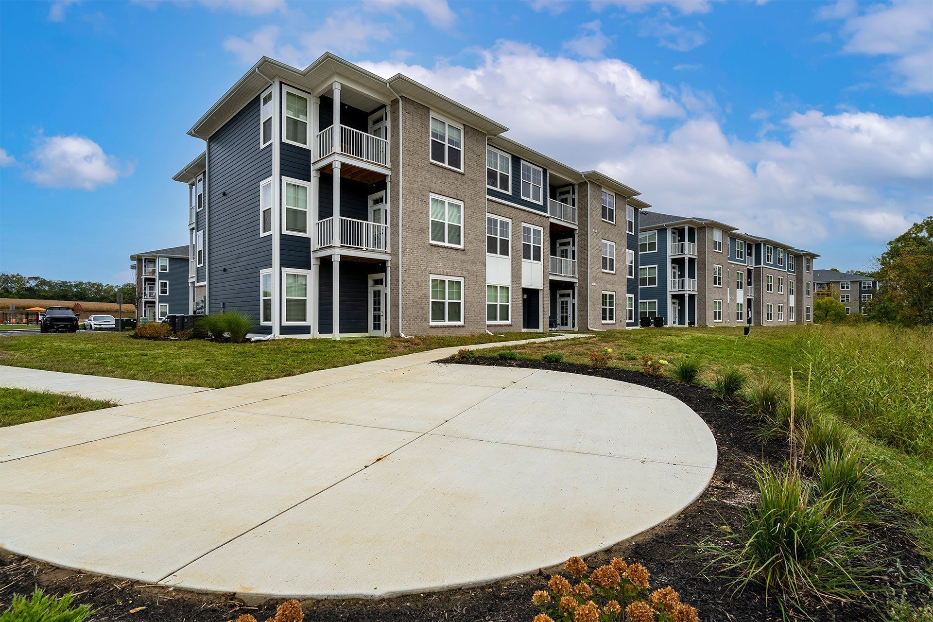 A large apartment complex with a circular driveway in front.