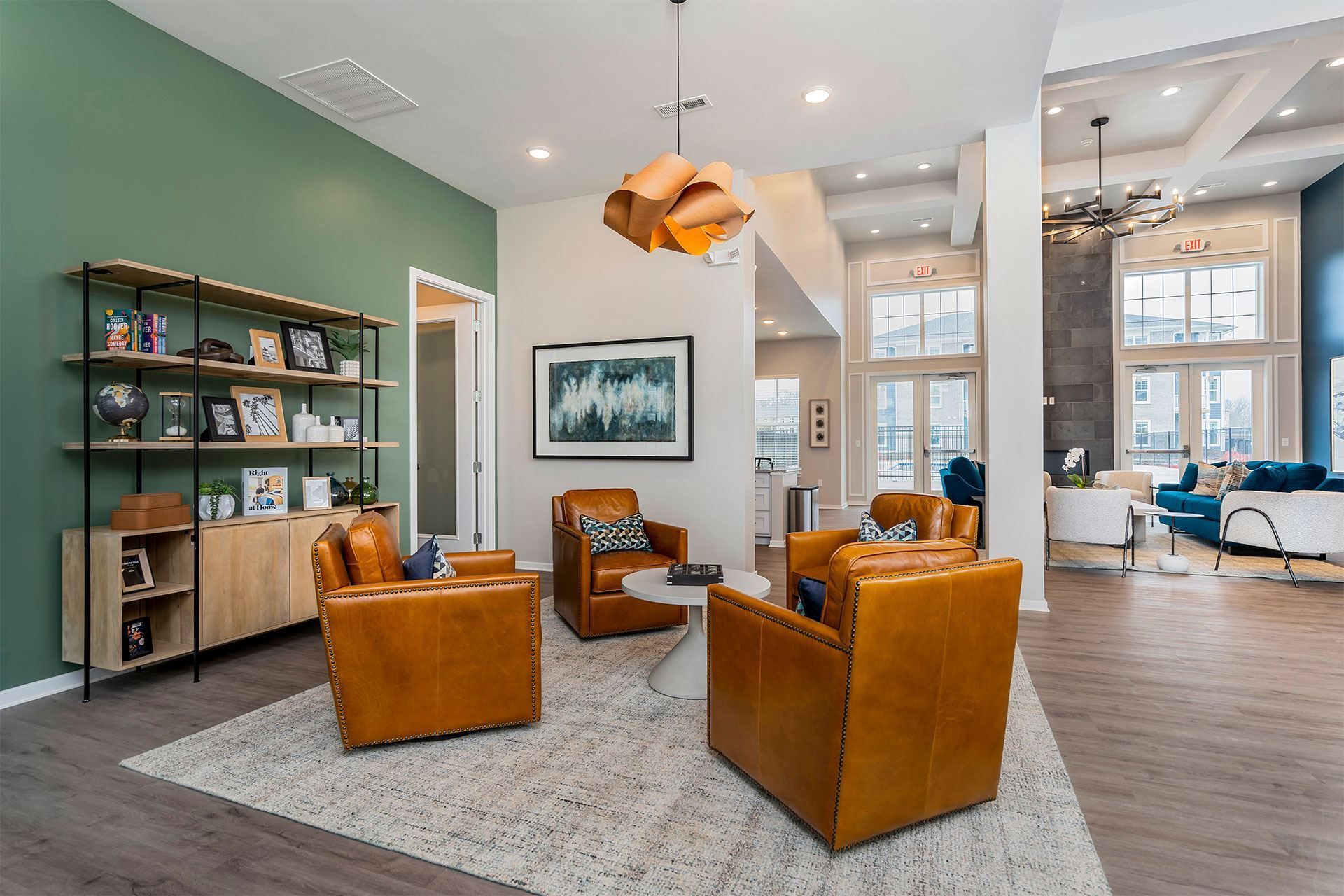 Resident lounge with a green wall and a painting hanging on it.