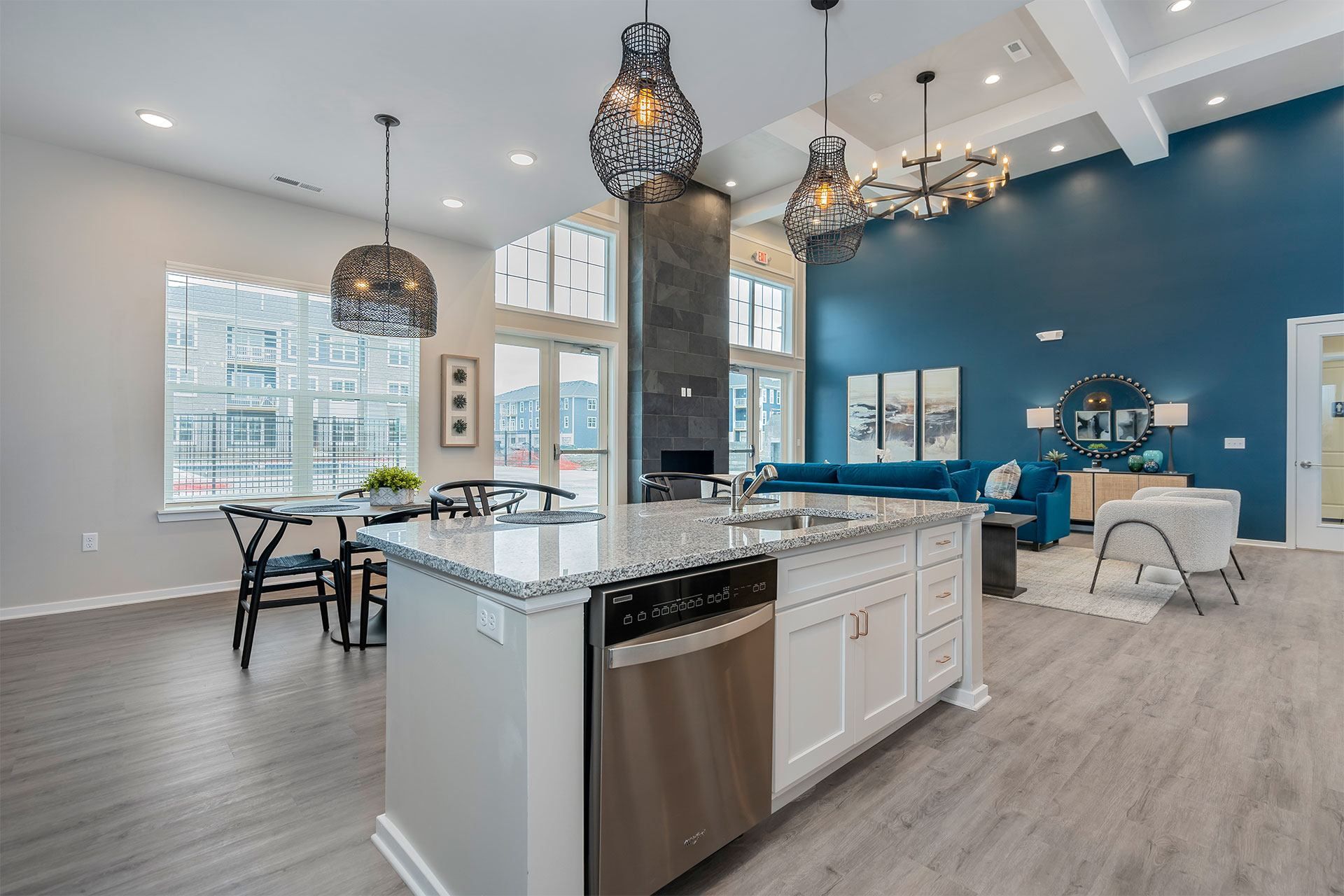 A modern kitchen with a large island and stainless steel appliances.