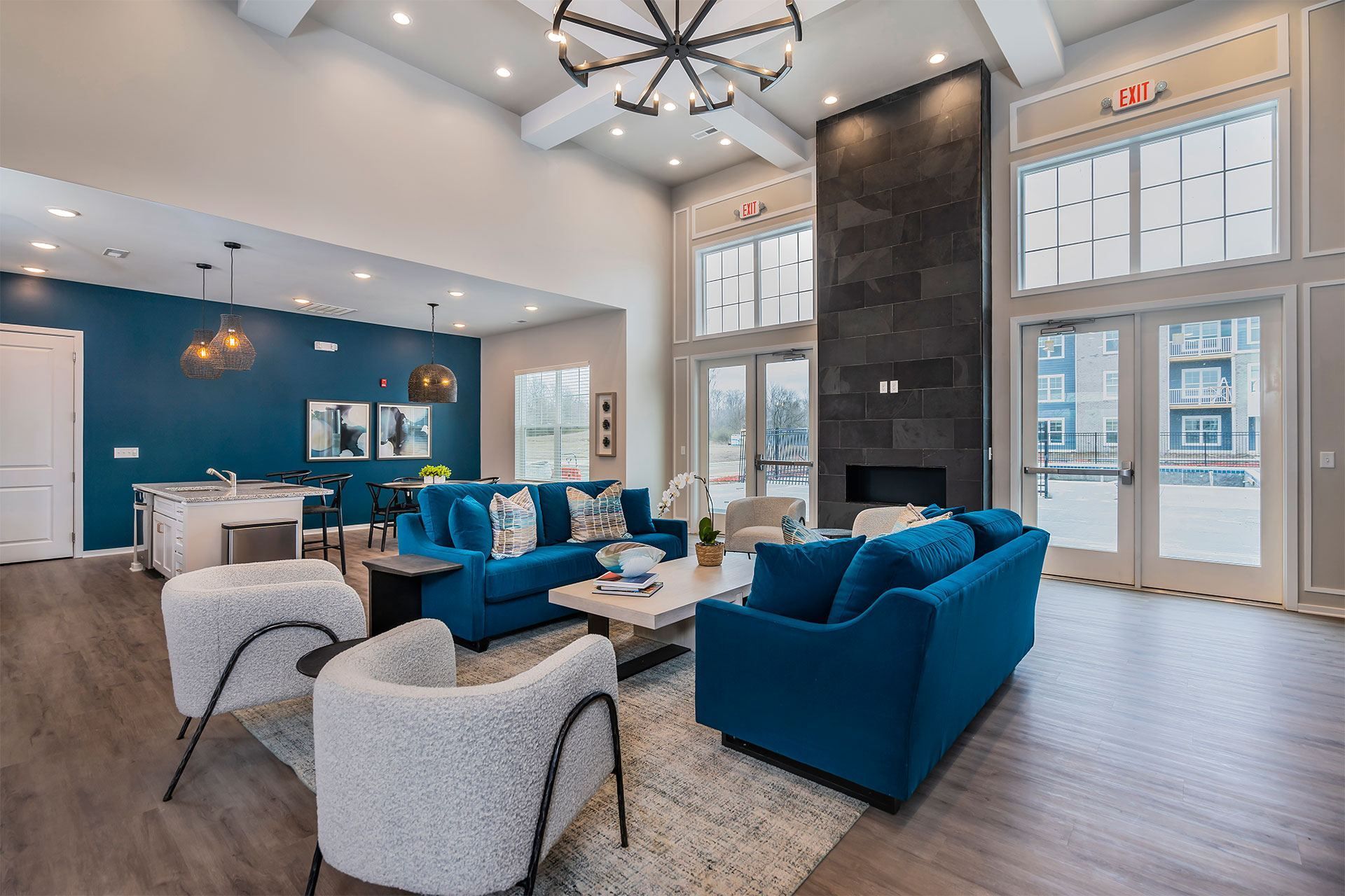 Resident lounge with a blue couch and a fireplace.