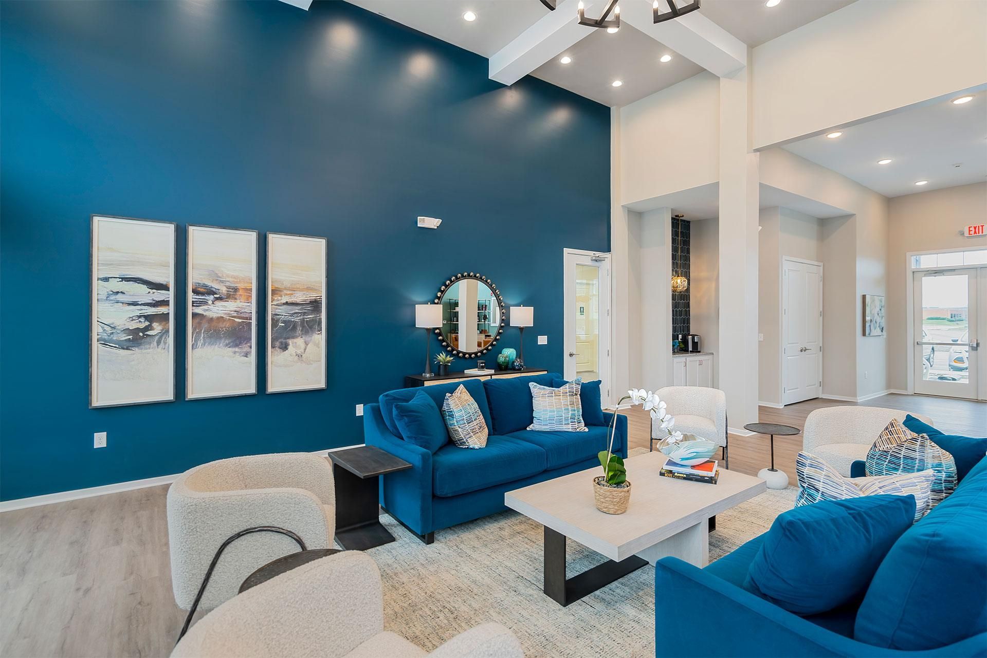Resident lounge with blue couches and a white coffee table.