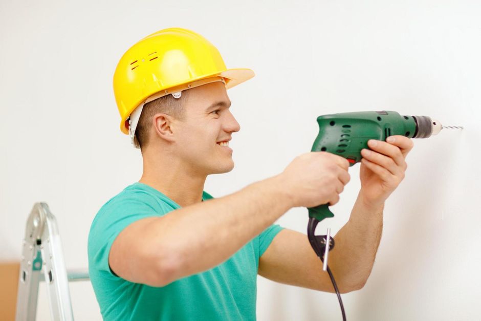 handyman drilling the wall