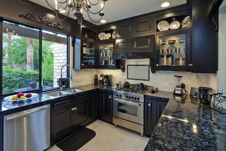 a kitchen with black marbled countertop