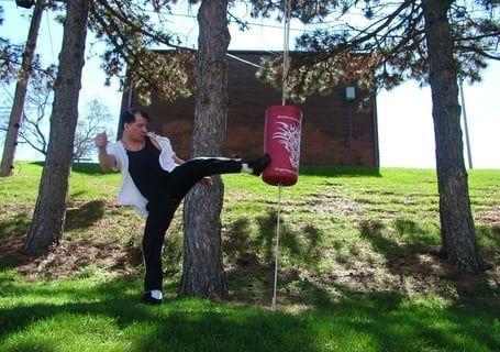 A man is practicing martial arts outdoor