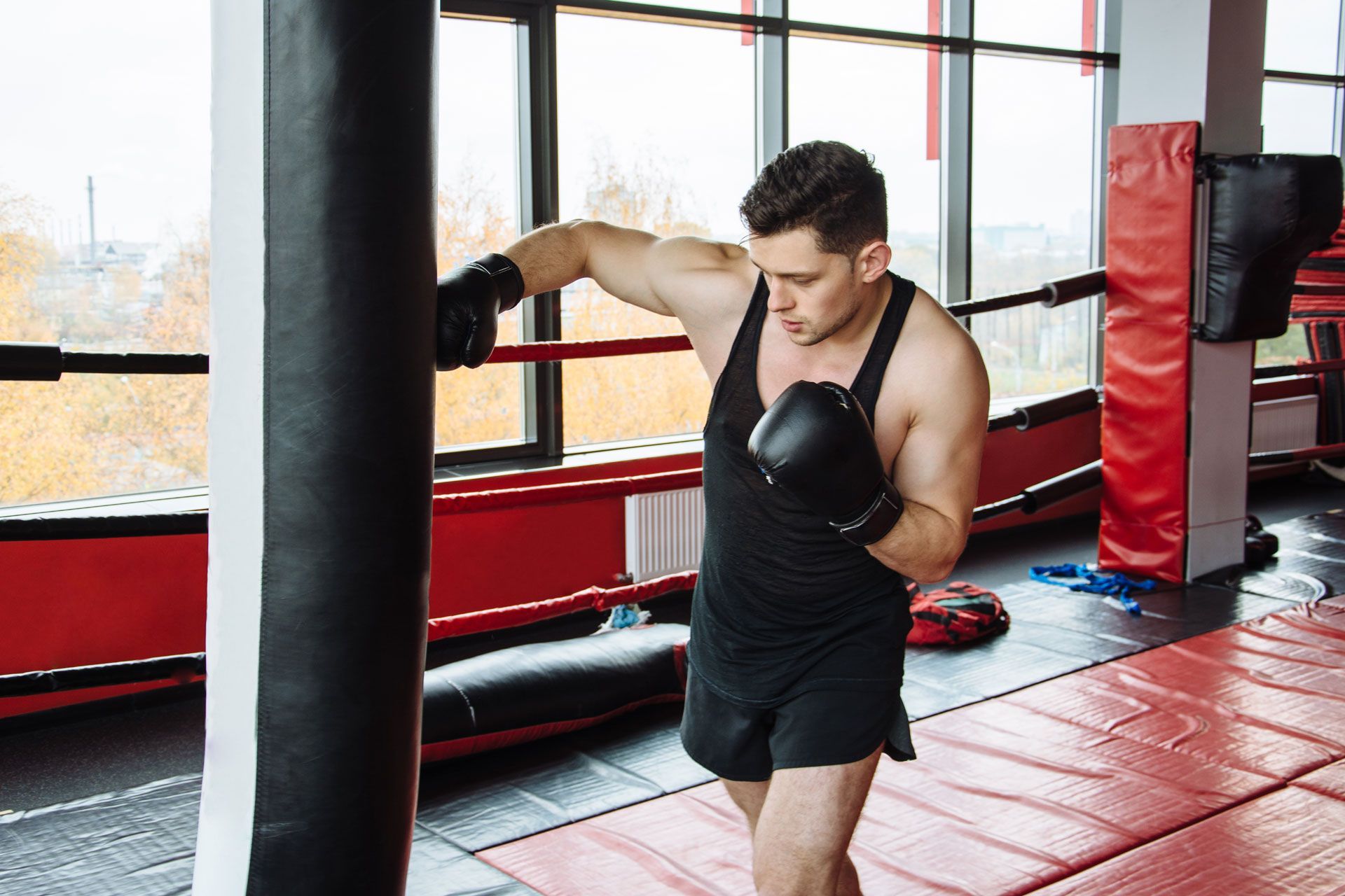 Man training in gym using a punching bag