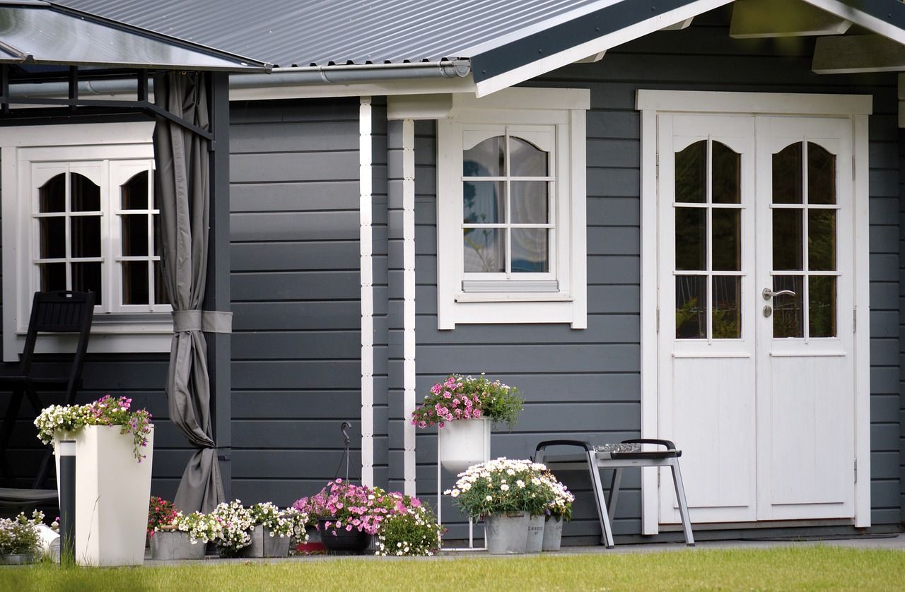 Close-up shot of a grey garden shed in a Reading home garden, expertly painted by Snowflake Decor.