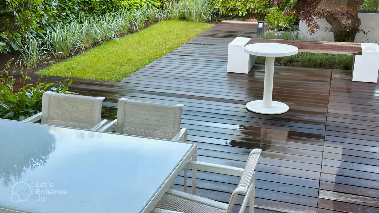 A wooden deck with a table and chairs on it