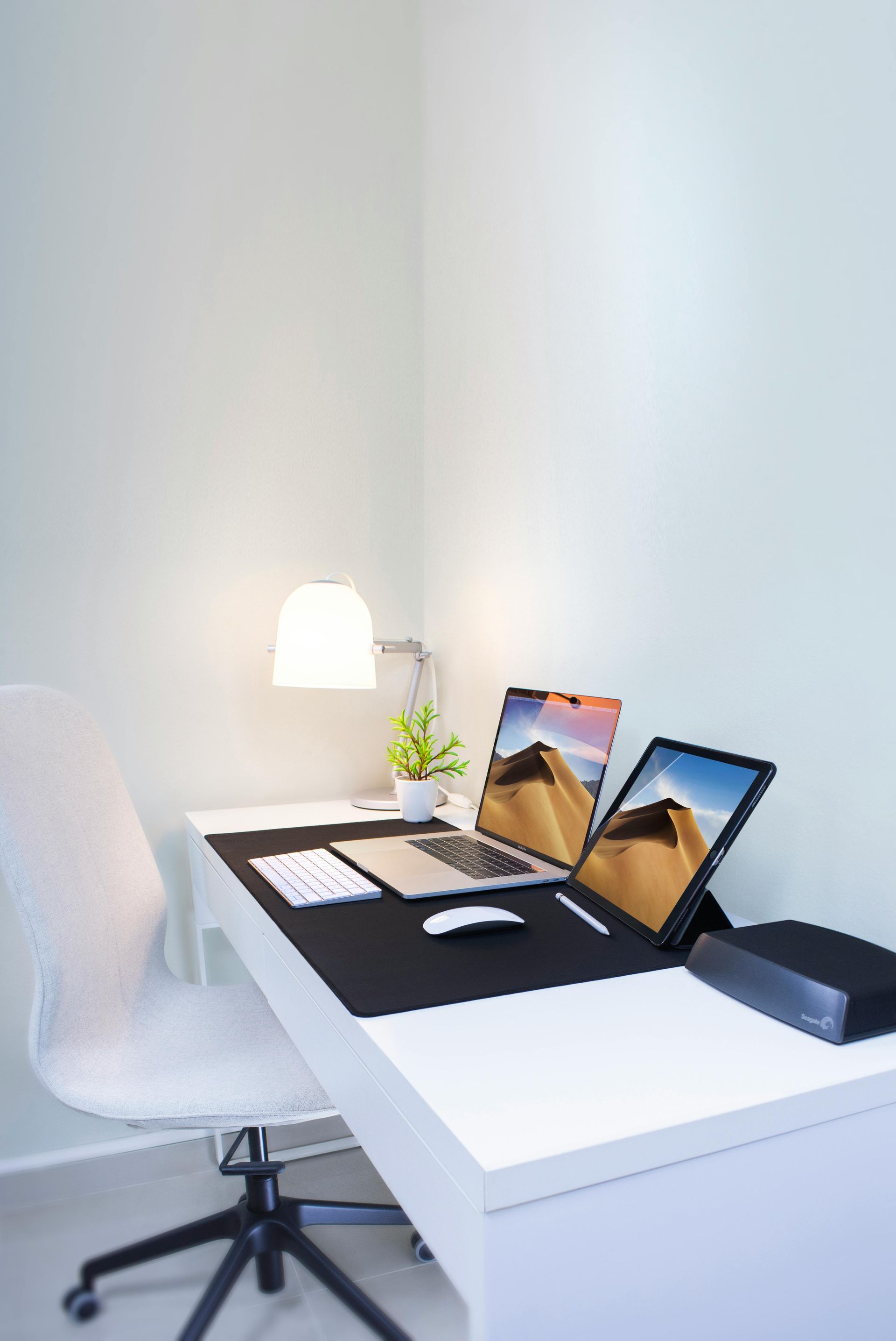 White painted office room with desk and chair and laptops