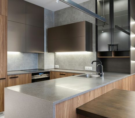 A kitchen with wooden cabinets and a stainless steel sink