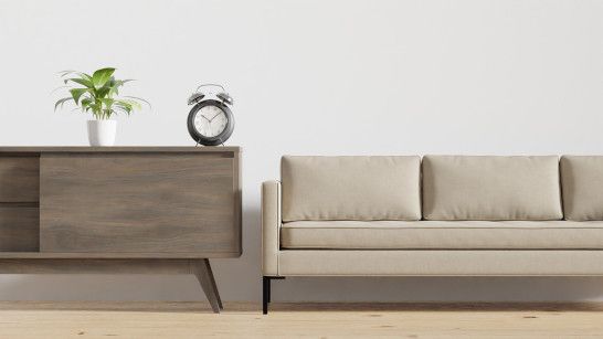 Casual seating area with wall clock and storage chest