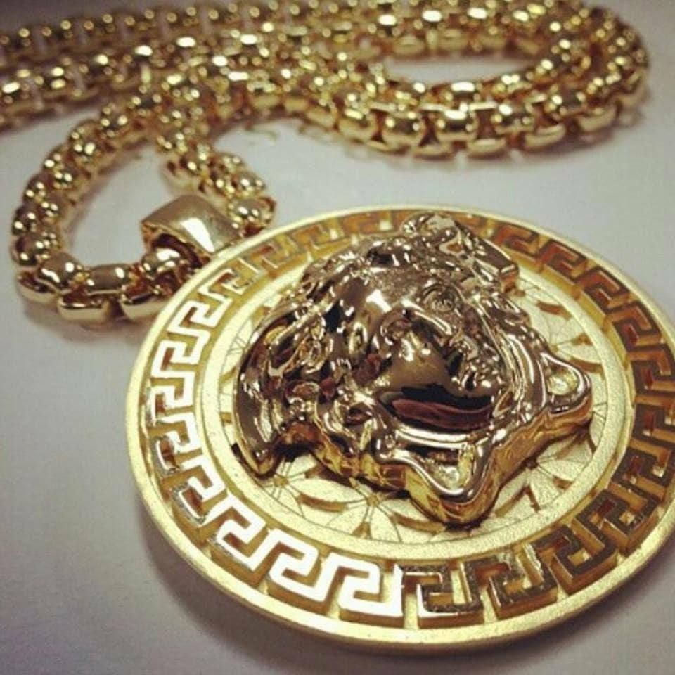 Gold Versace necklace with a Medusa pendant.