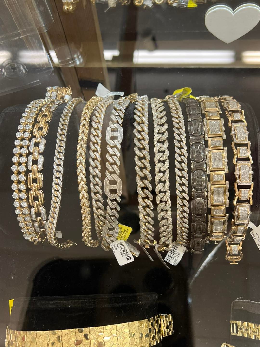 Display case of gold and diamond bracelets.