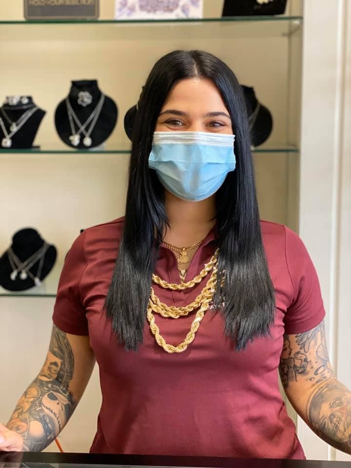 Woman wearing a mask and jewelry in a jewelry store.