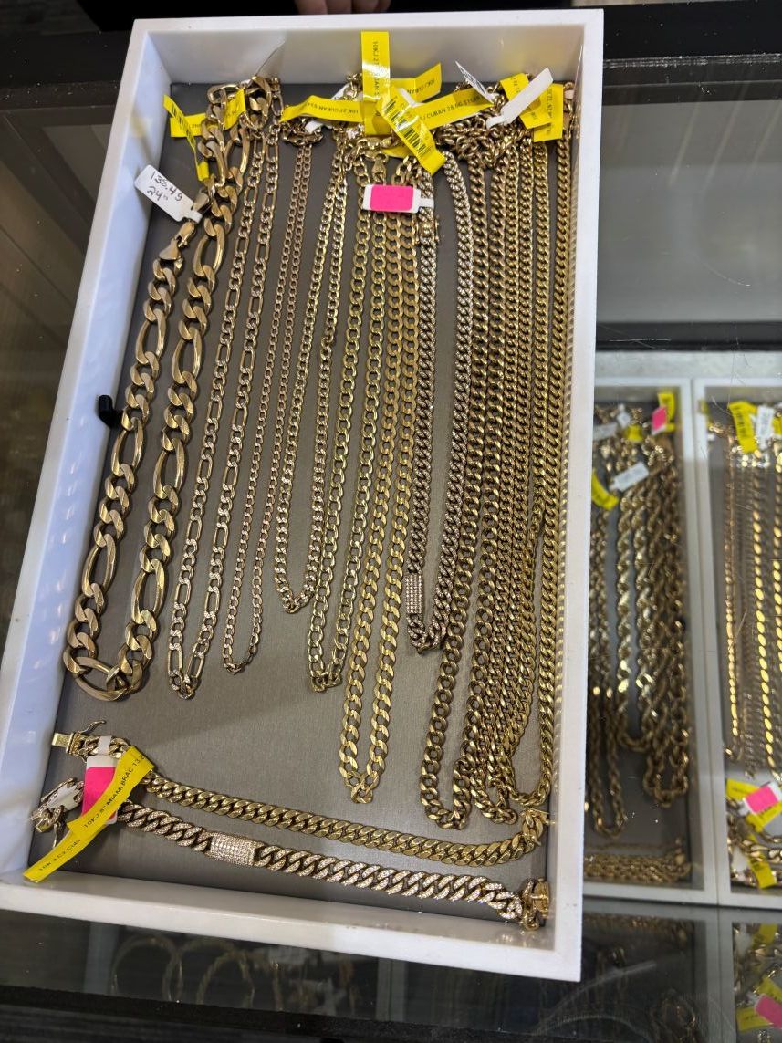 Gold chains and bracelets in display cases.