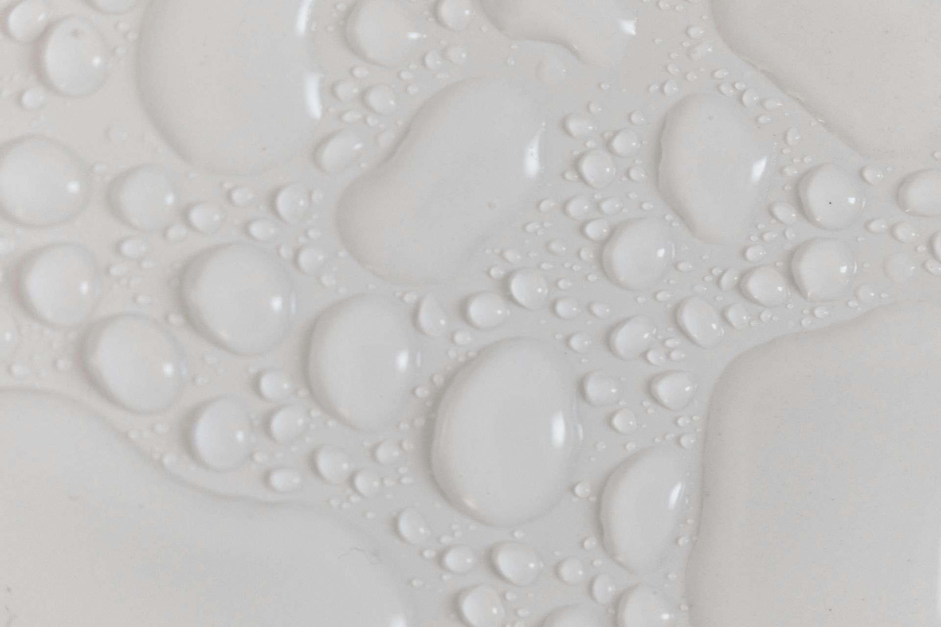 A white wall with water drops, indicating an obvious leak