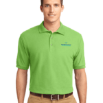 A man is wearing a green polo shirt and khaki pants.