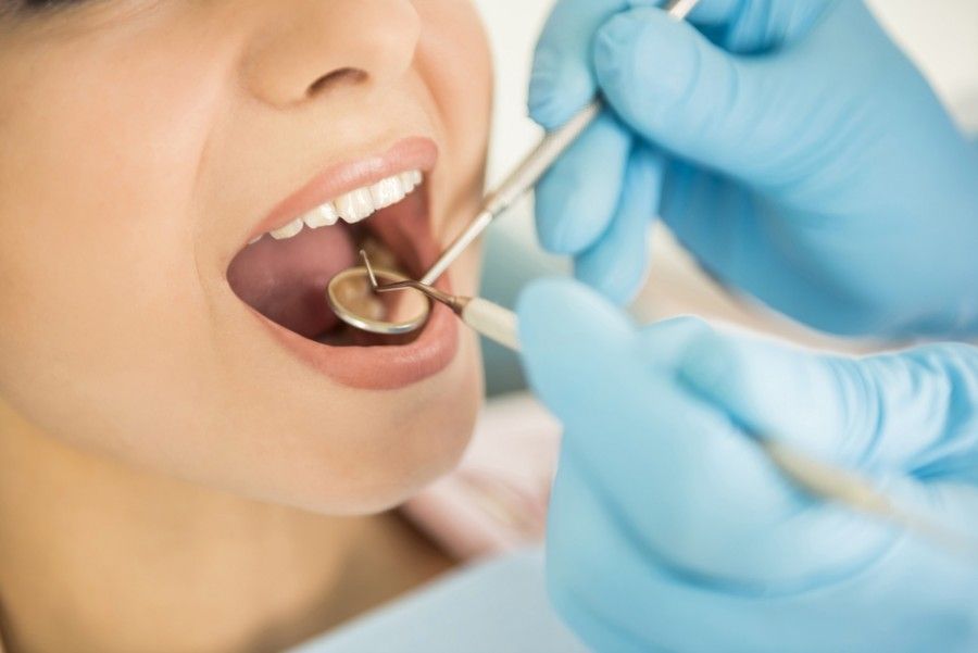 A Woman is Getting Her Teeth Examined by a Dentist — ProCare Dental Australia in East Maitland, NSW