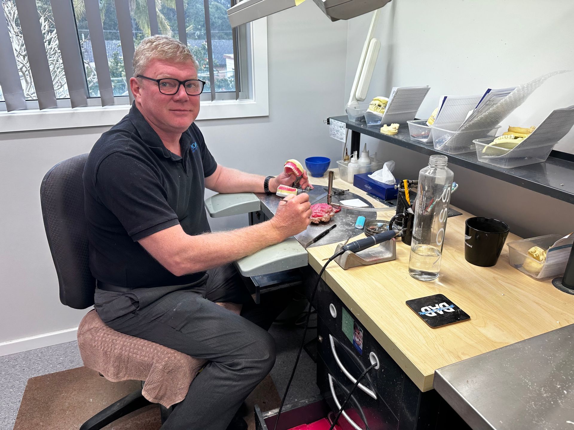 A Dentist is Working on a Denture in a Dental Office — ProCare Dental Australia in East Maitland, NSW