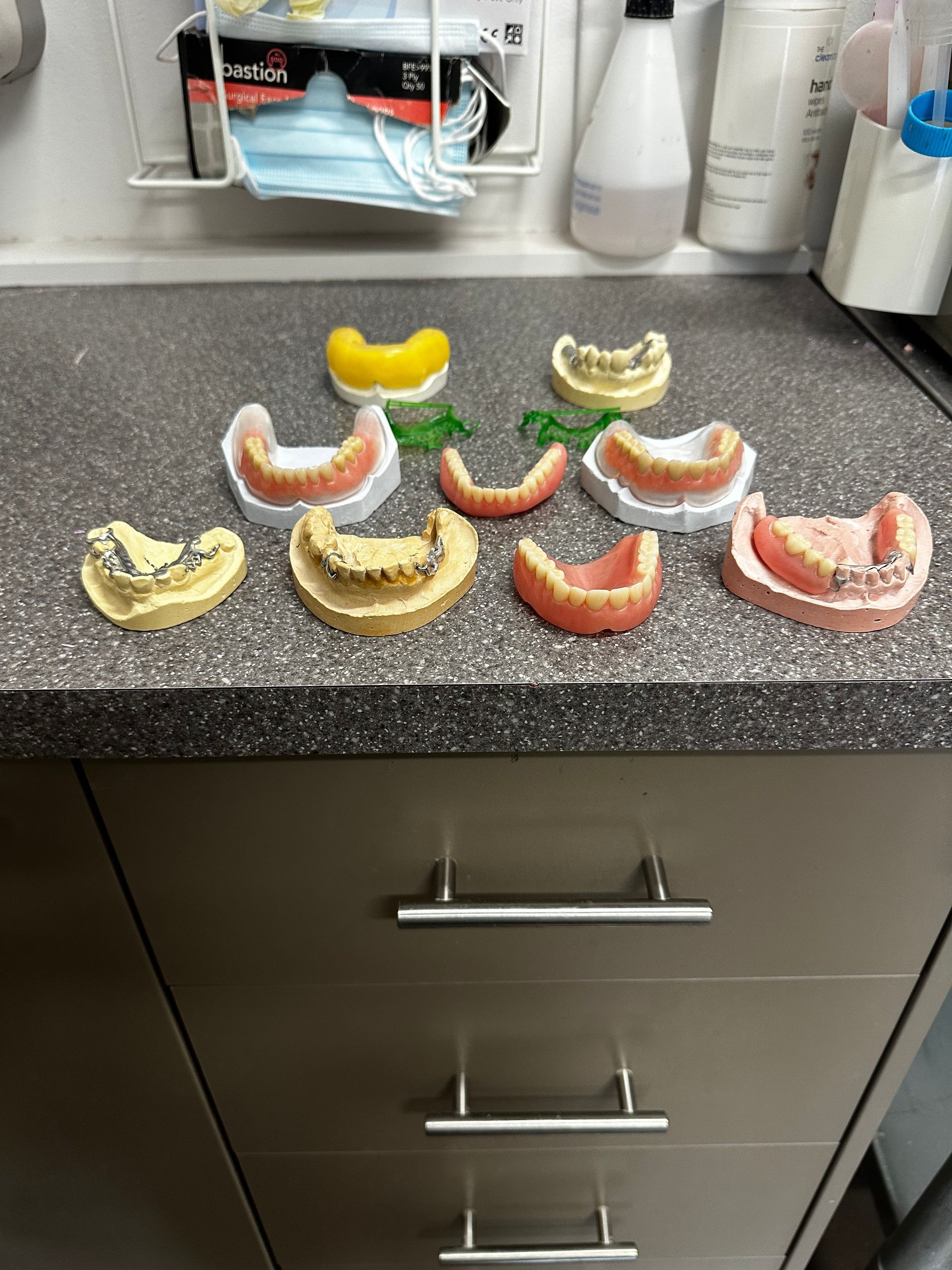 A Bunch of Dentures Are Sitting on Top of a Counter — ProCare Dental Australia in East Maitland, NSW