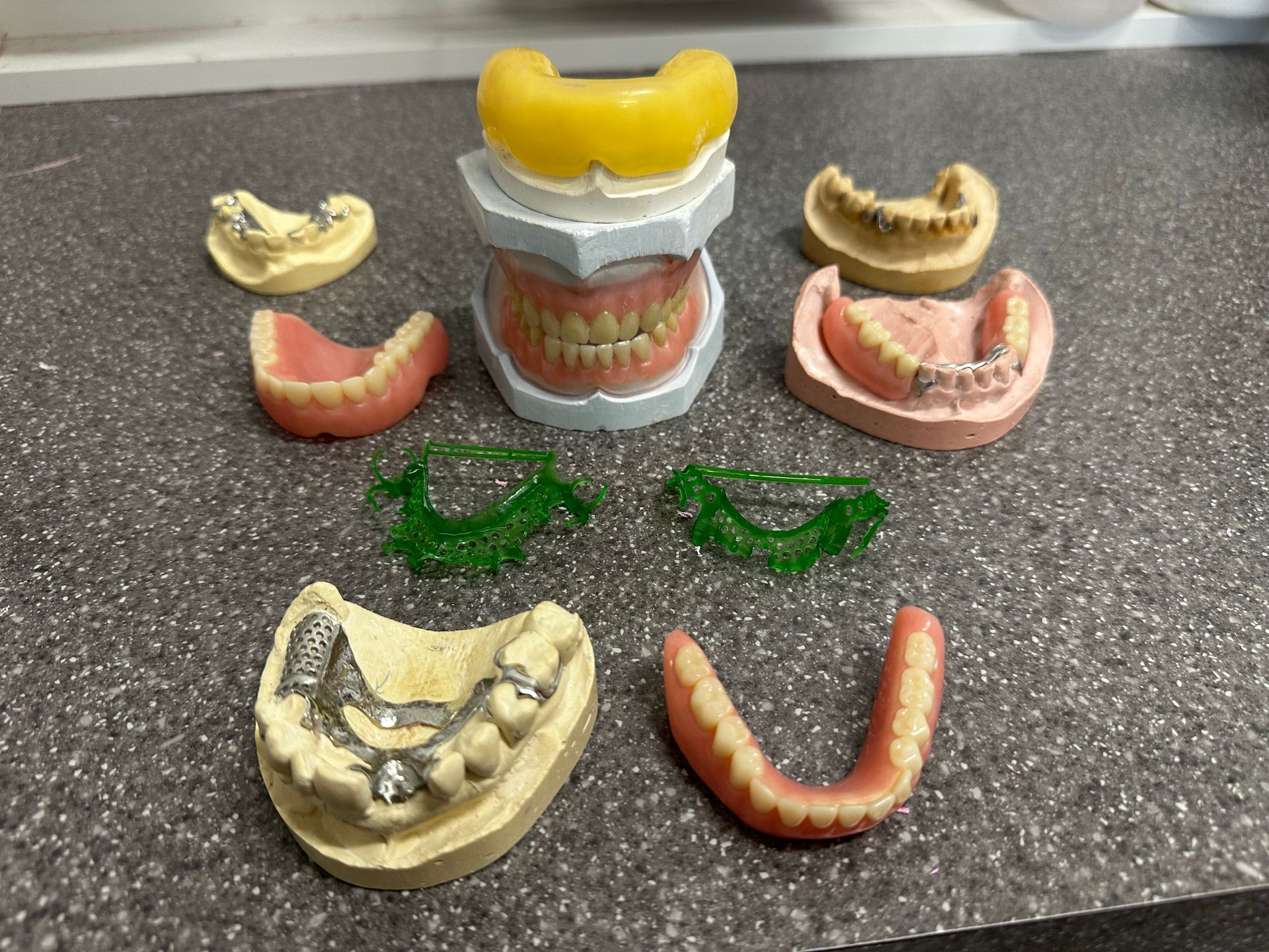 A Dentist is Examining a Model of Teeth With a Dental Mirror — ProCare Dental Australia in East Maitland, NSW