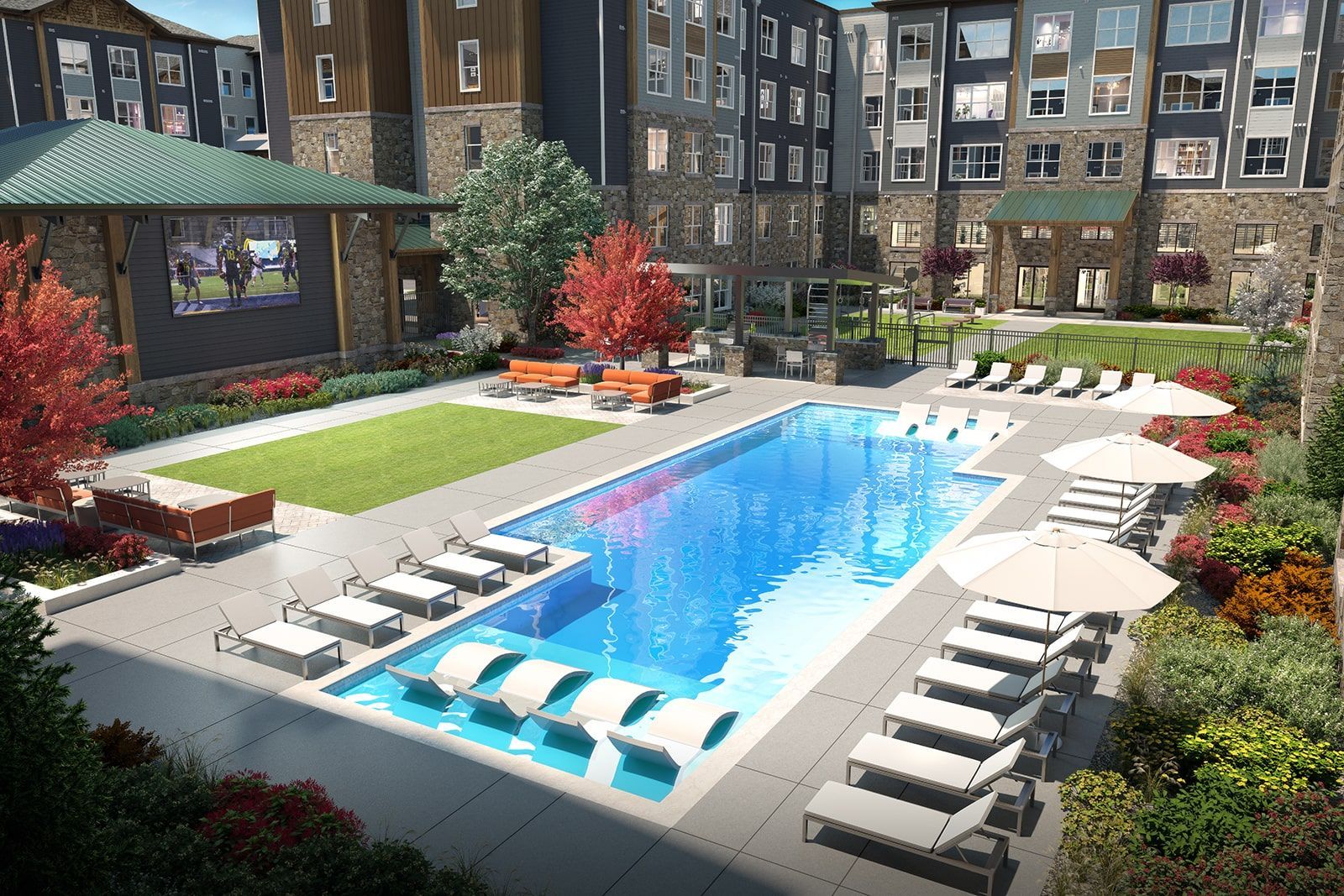 Outdoor pool area at a multifamily community with lounge chairs, umbrellas, and landscaped surroundings.