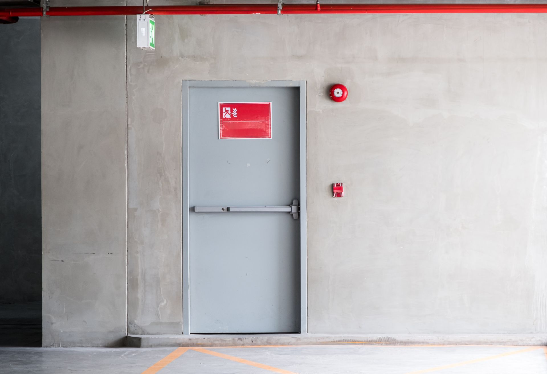 A grey fire exit door at a commercial building for an emergency case