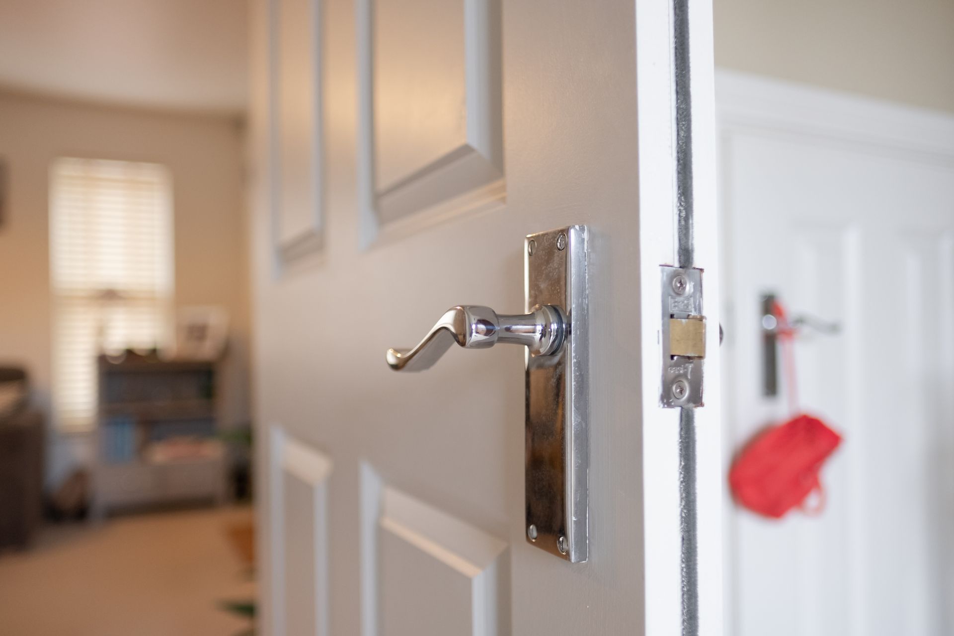 Shallow focus of an interior door handle seen on a fire door.
