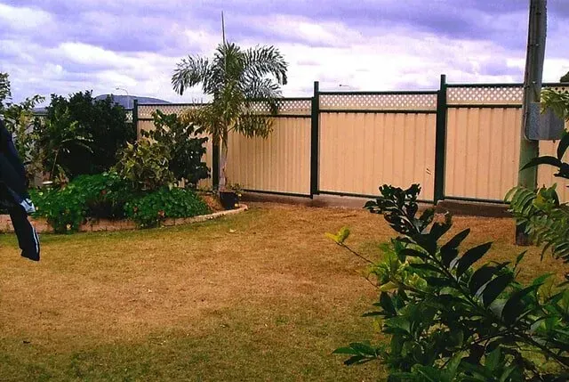 A Backyard With A Fence And A Few Plants — Rockhampton Powdercoating & Fence Panels in Park Avenue, QLD