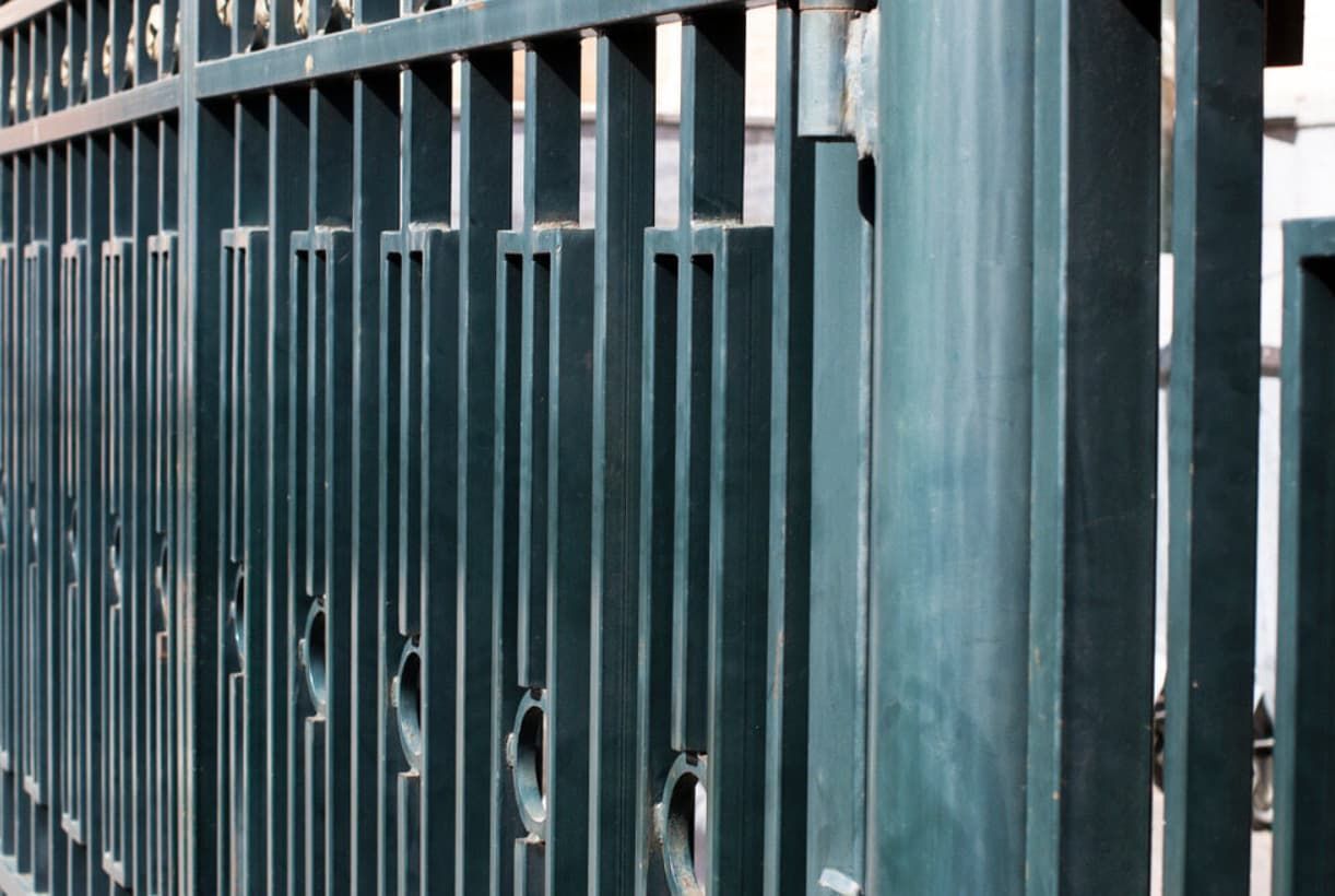A Close Up Of A Metal Fence With Holes In It — Rockhampton Powdercoating & Fence Panels in Park Avenue, QLD