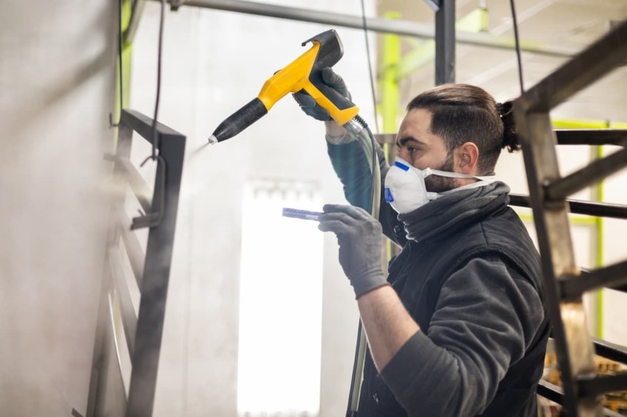A Man Sandblasting A Metal — Rockhampton Powdercoating & Fence Panels in Park Avenue, QLD