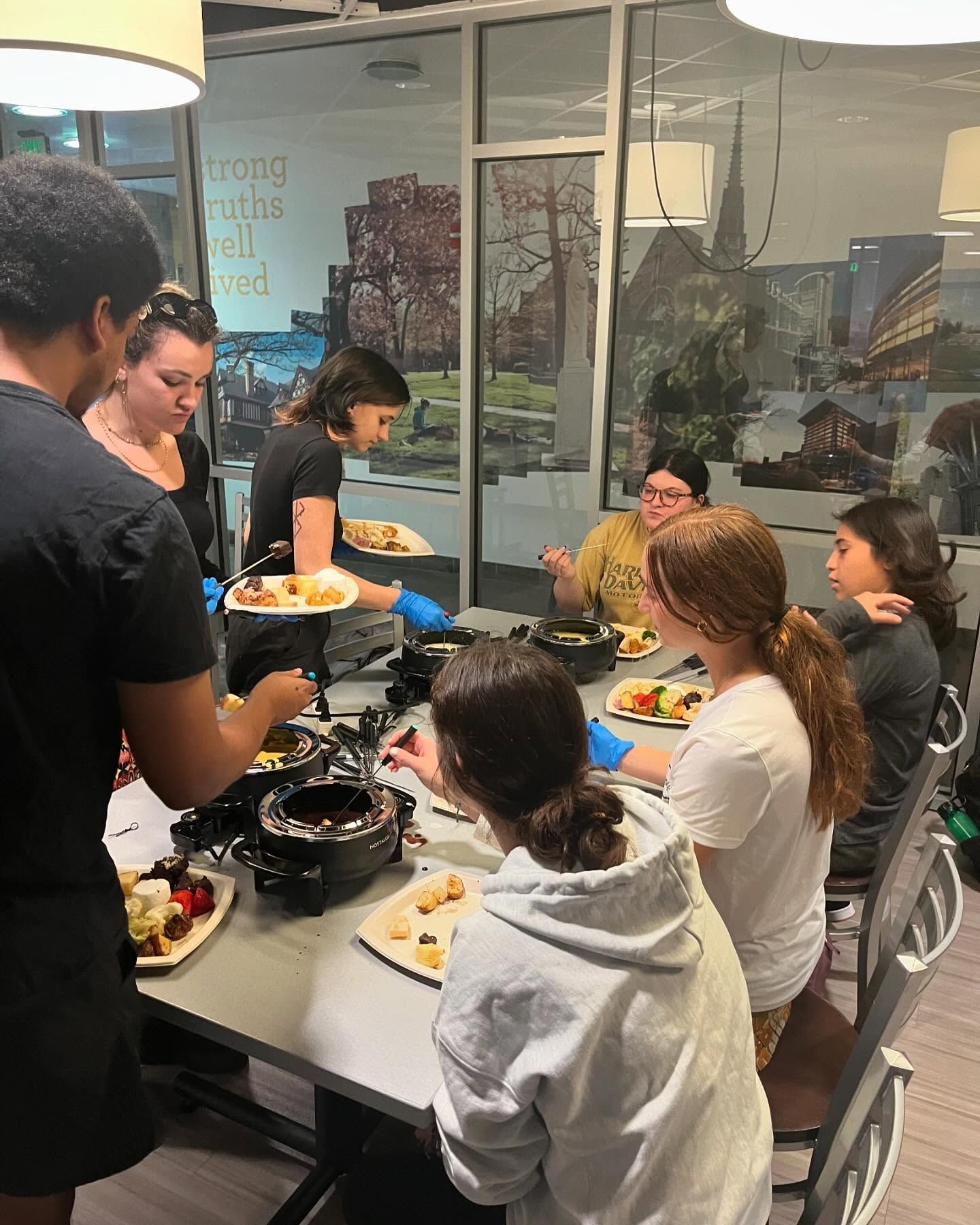 A group of people are sitting at a table eating food.