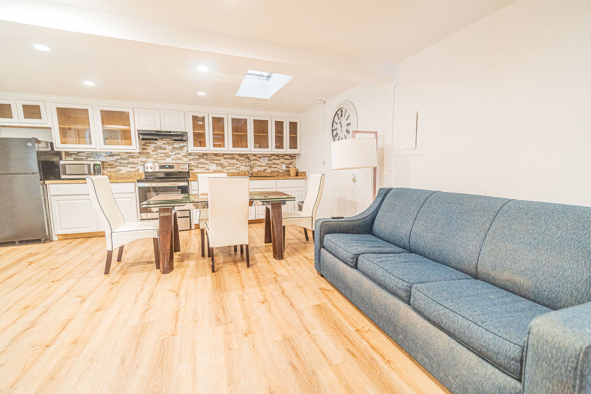 Open-concept living space with kitchen and sitting area. 