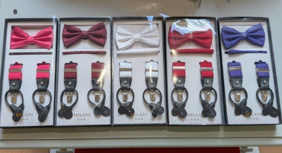 Bow tie and suspender sets in boxes, different colors.