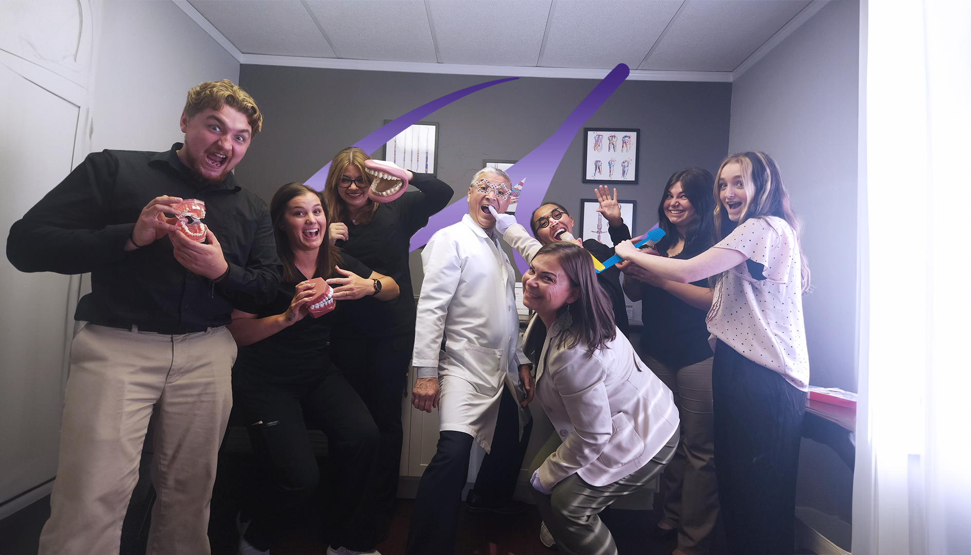A group of people are posing for a picture in a room.