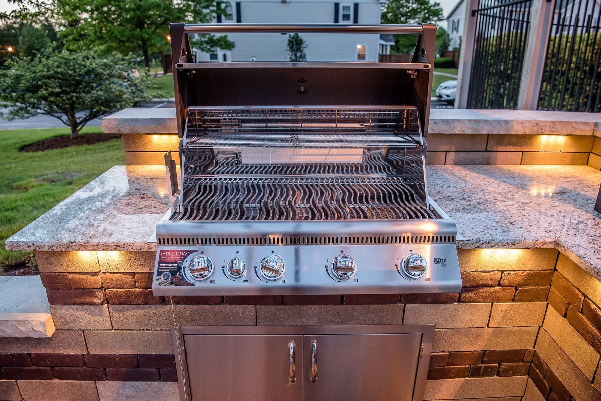 a stainless steel grill is sitting on top of a granite counter top .