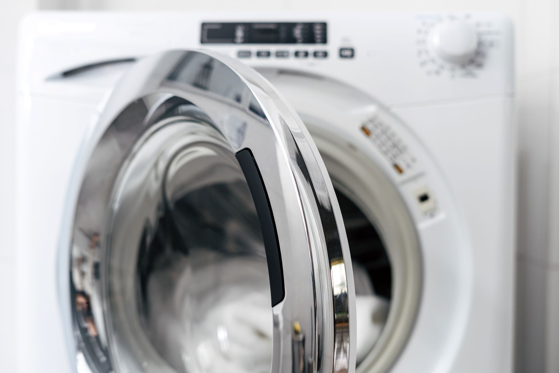a close up of a washing machine with the door open .