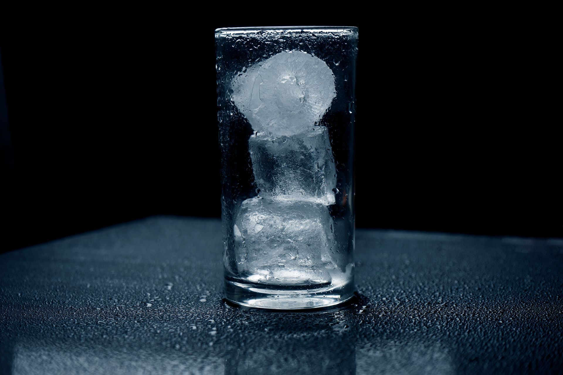 Pure ice cube on darken background.