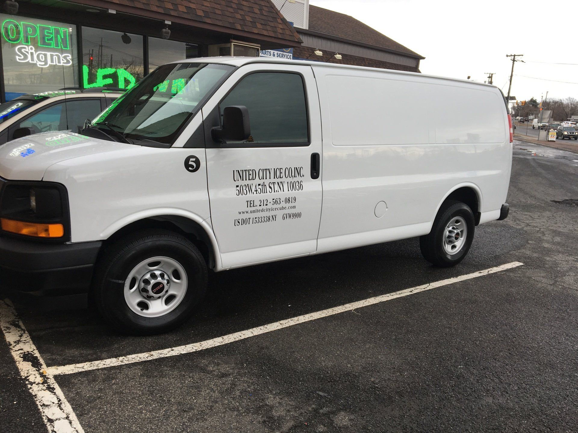 A white van is parked in a parking lot