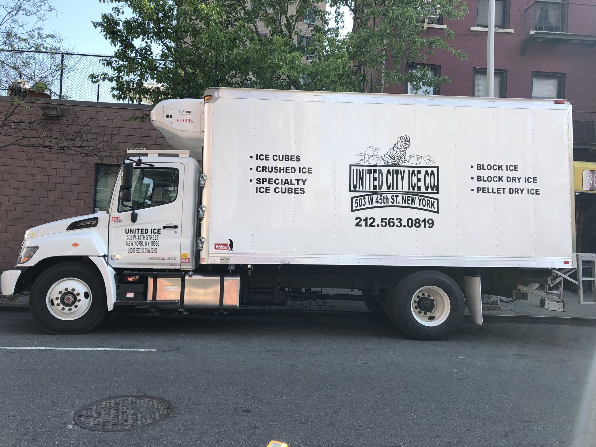 A white truck is parked on the side of the road.