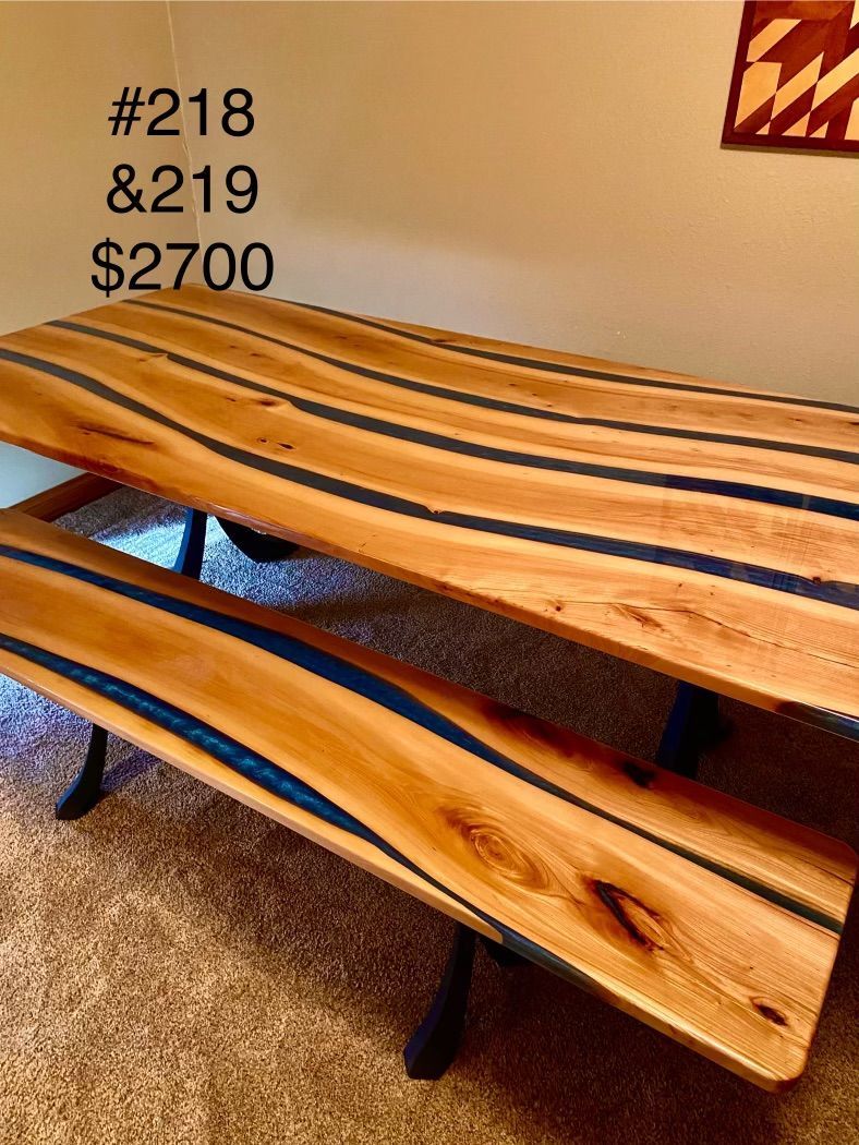 A wooden picnic table with two benches is for sale.