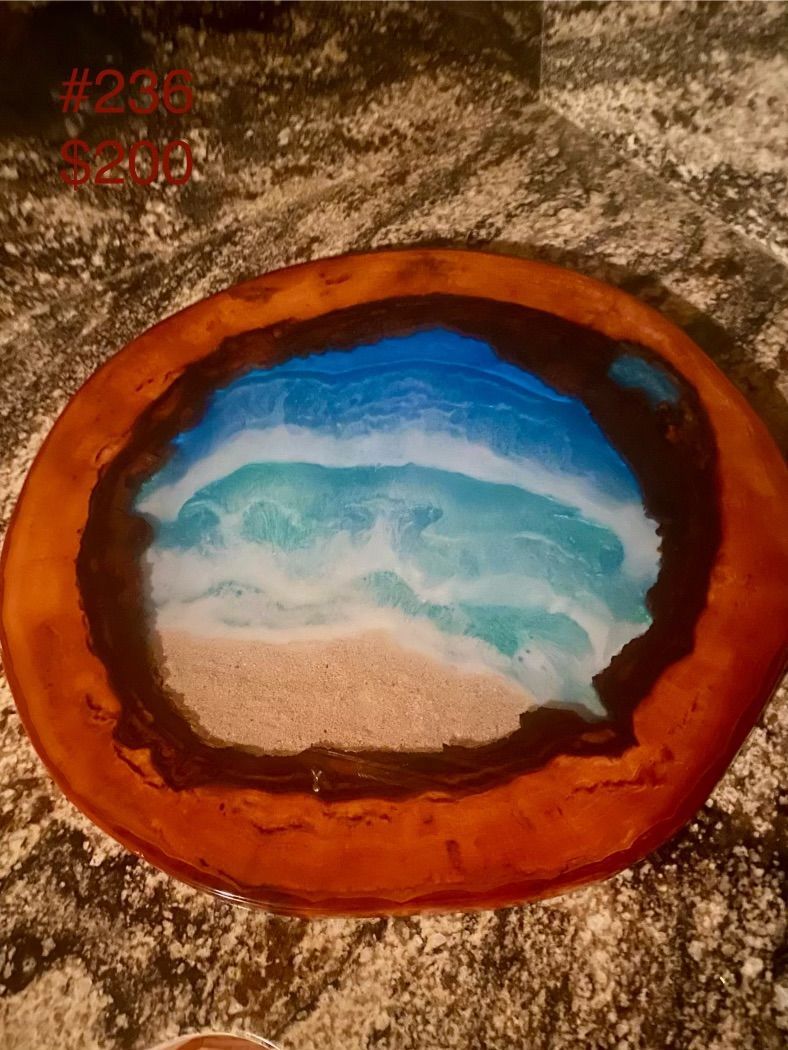 A painting of a beach in a circle on a table.