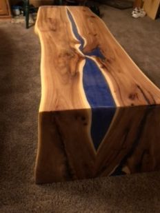 A wooden table with a blue river running through it