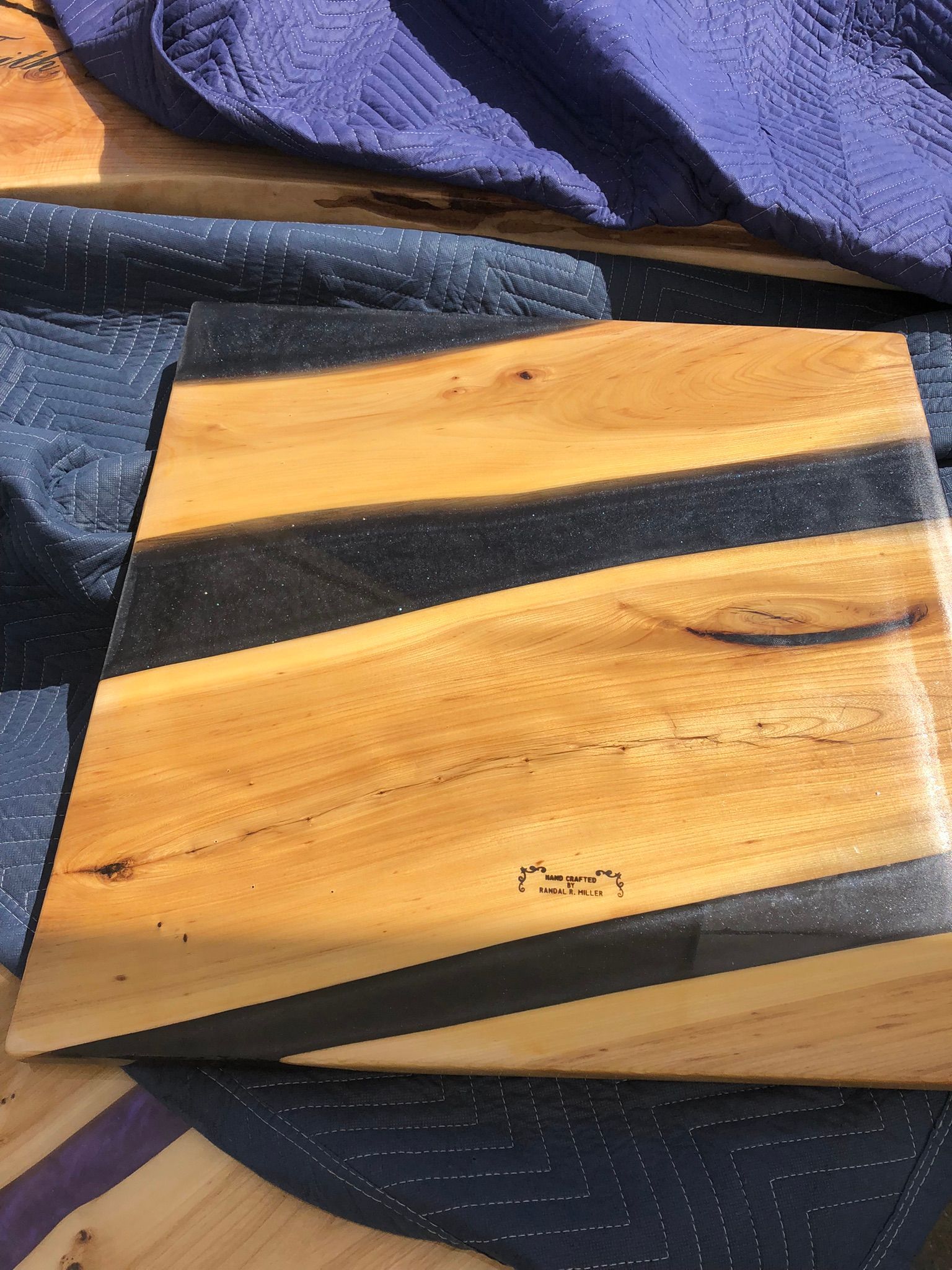 A wooden cutting board with black stripes on it is sitting on a table.