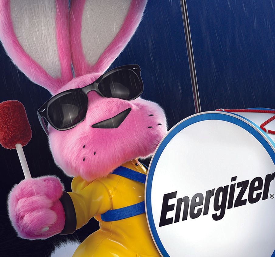 A pink energizer bunny holding a lollipop and a drum