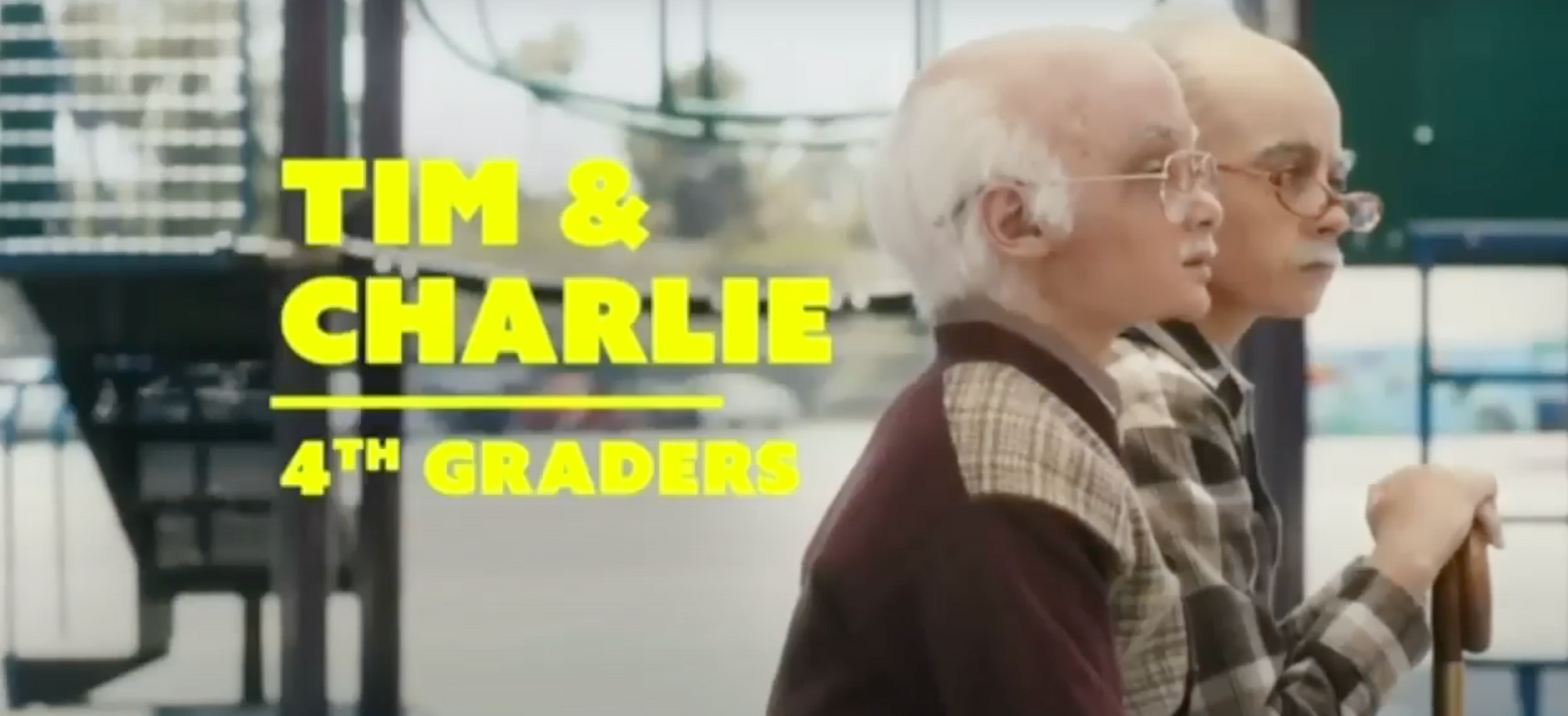 Two older men sitting next to each other with the words tim & charlie 4th graders above them