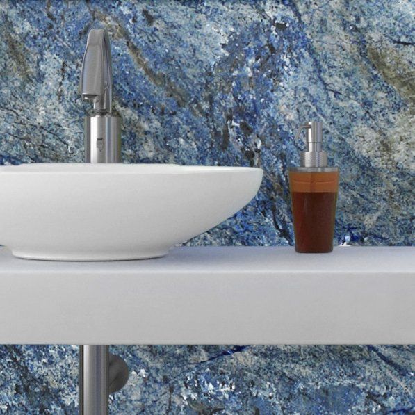 A bathroom sink with a soap dispenser next to it