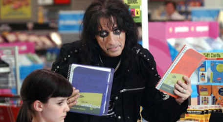 A man is reading a book to a girl in a store.