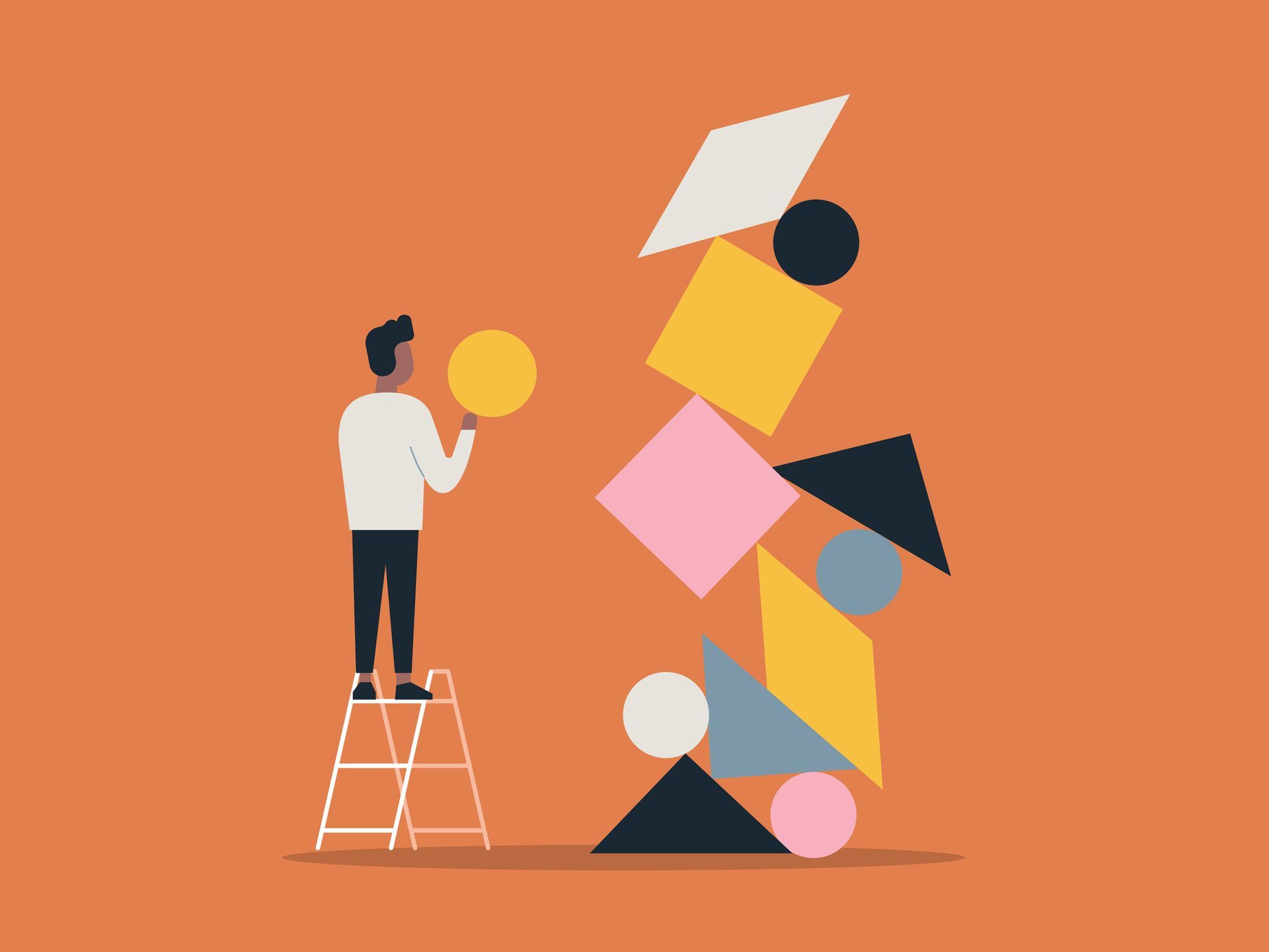 A man is standing on a ladder stacking geometric shapes.