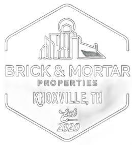Brick & Mortar Properties logo: white outline of city skyline within a hexagon, text