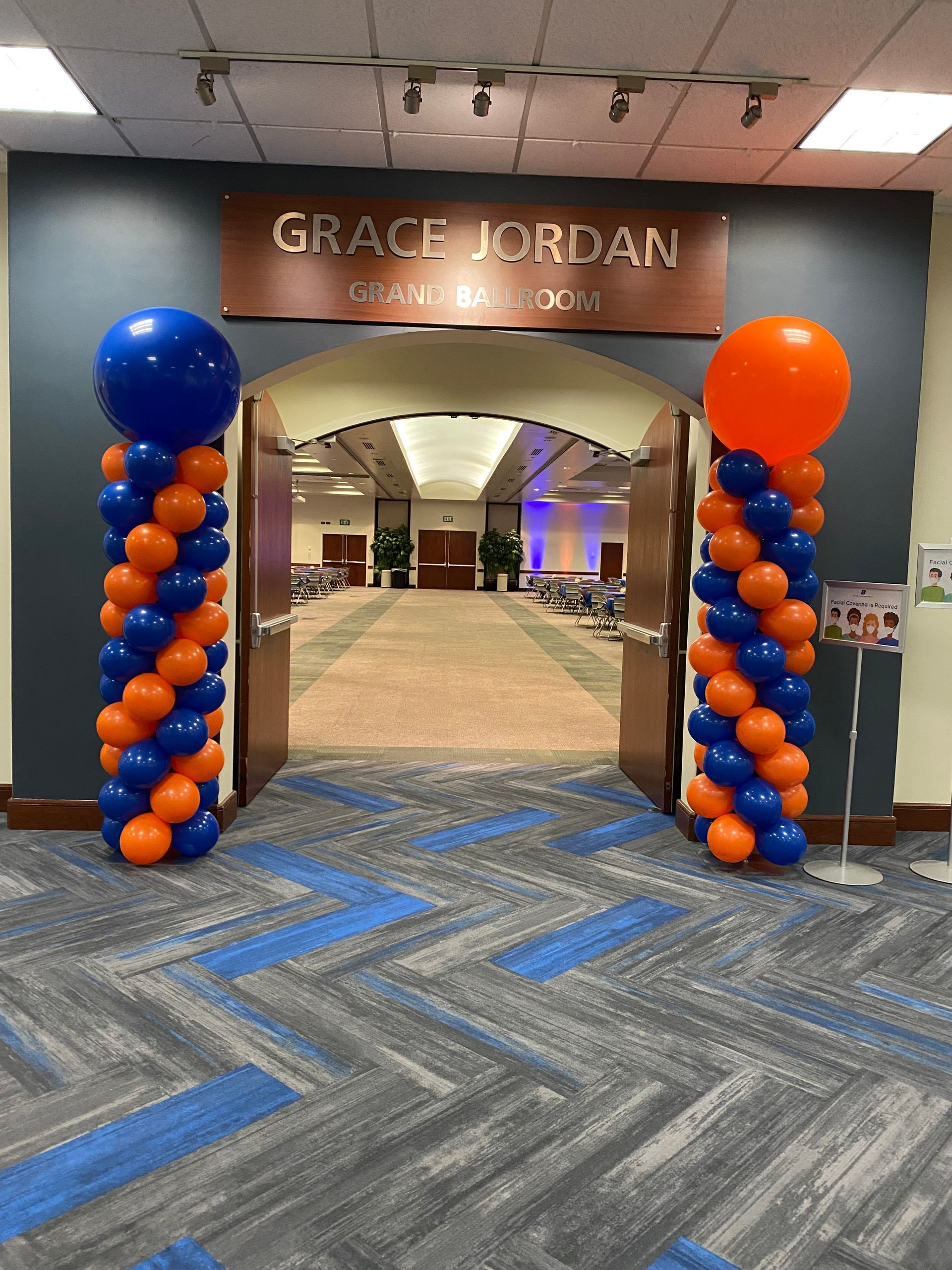 A hallway with balloons and a sign that says grace jordan